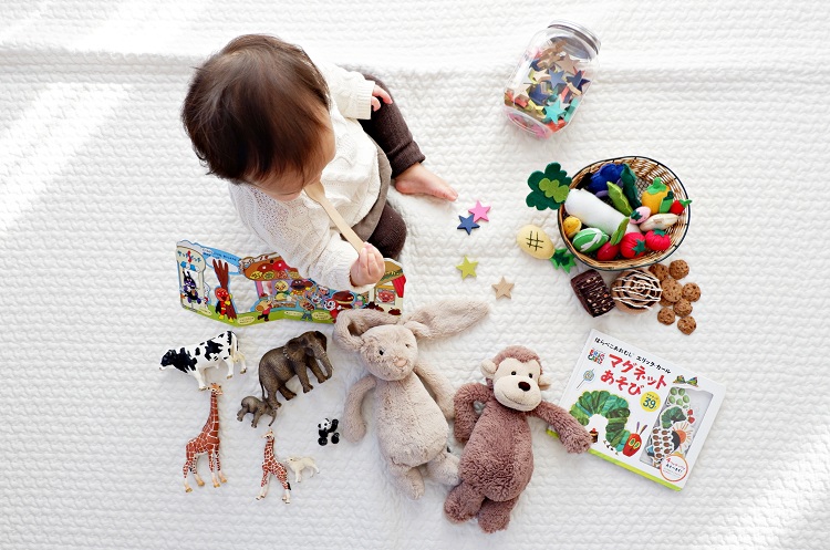 baby surrounded by gifts unsplash